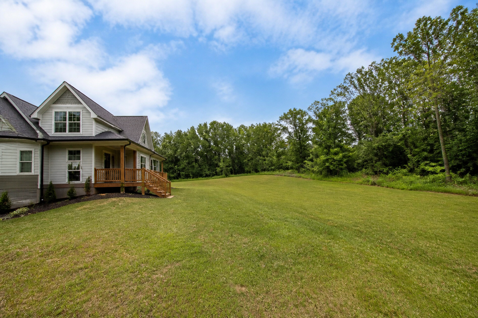 A house with adjacent grassy land beside it